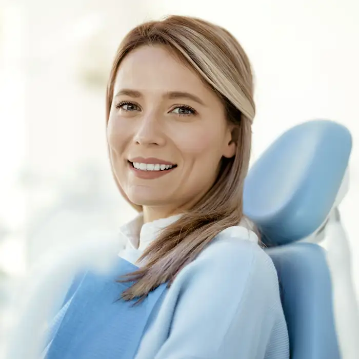 woman smiling in a dentist's chair